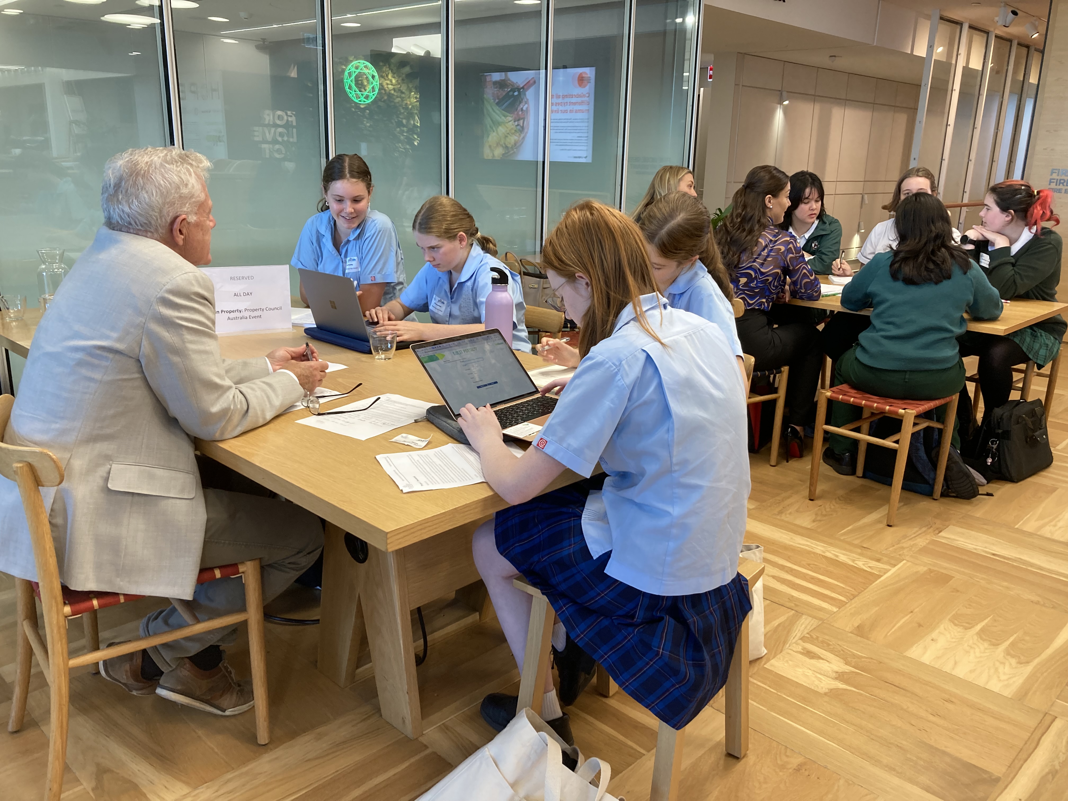 Female school children sitting around a desk Female school children sitting around a desk