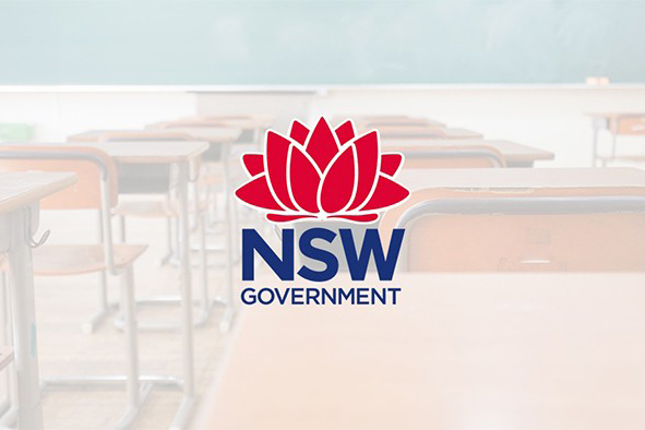 Logo_with_desk A row of desks with the government logo superimposed on the image.